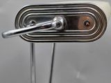 a close up of a metal door handle on a white door