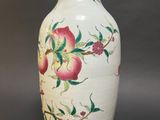 a white vase with a floral design on it