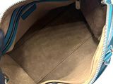 the inside of a blue purse with a zipper on it