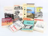 several books are stacked on top of each other on a white surface