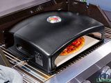 a pizza oven with a pizza on top of it