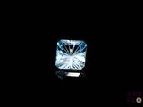 a close up of a blue diamond on a black background