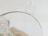 a wine glass with a green stem inside of it