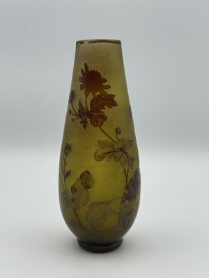 a yellow vase with a floral design on it