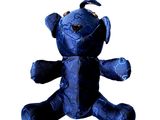 a blue teddy bear with a bird on it ' s head