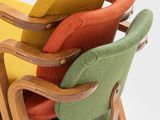 brightly colored chairs stacked on top of each other on a white surface