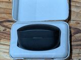 a white box with a black lid on a wooden table