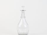 a clear glass bottle with a stopper on top of it