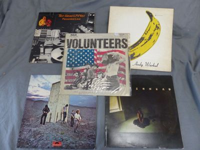 several albums and records are laying out on a blue sheet