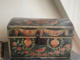 a small wooden box sitting on top of a dresser
