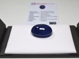 an image of a blue sapphire sits in a box on a white surface
