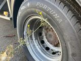 a flat tire on a flatbed truck parked on the side of the road