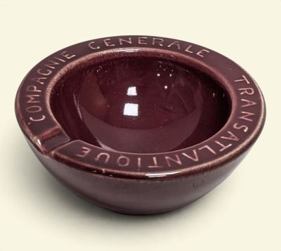 a small brown bowl with writing on it