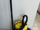 a yellow vacuum cleaner on the floor next to a white wall