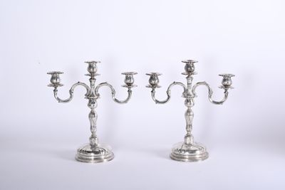 three silver candelabs on a white background with a white background
