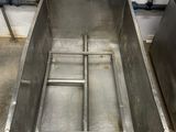 a stainless steel sink in the middle of a room