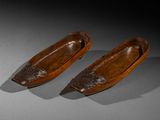 pair of carved wooden boats sitting on top of a table