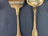 a lot of silver spoons and forks on the table