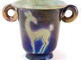 a blue vase with a deer on it on a white background