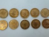 a bunch of coins sitting on top of a table next to each other