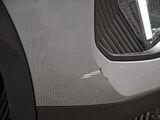 a close up of a car ' s front bumper with a hole in it