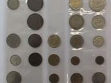 several different types of coins are displayed on a white surface