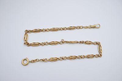 a pair of gold chain bracelets with clasps