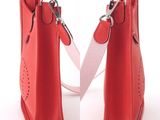 two red purses with a white strap on a white background