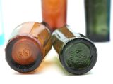 three empty wine bottles sitting next to each other on a table
