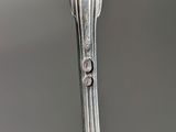 a silver spoon with a spoon handle on it