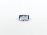 a close up of a blue sapphire stone on a white surface