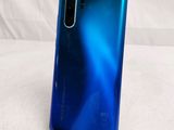 a close up of the back of a blue and black phone
