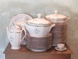 a stack of dishes and cups sitting on a table