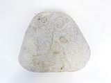 a rock with a drawing on it on a white surface