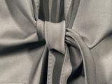 a close up of a tie on a gray shirt