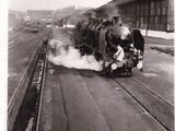 a black and white photo of a train on the tracks