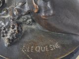 a bronze statue of a man with a hat on his head