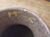 a close up of a vase on a wooden table