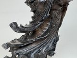 a statue of a woman sitting on a chair