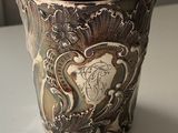 a silver cup that is sitting on a table