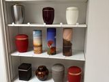 many different vases on the shelves in this cabinet