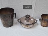 three metal buckets sitting on top of a table next to each other