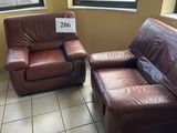 two leather couches and a chair in a room