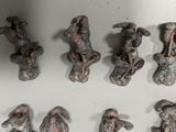 many small figurines that are on a white surface