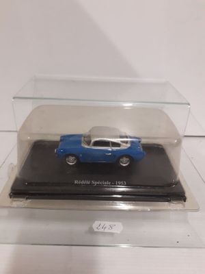 a small blue car in a clear case