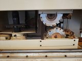 a machine that is working on a piece of wood