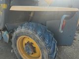 a tractor that is parked on the side of the road