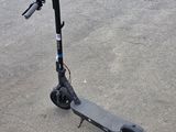 a scooter that is sitting on the ground in the parking lot