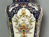a large blue and white vase sitting on a wooden table
