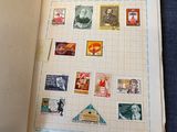 an open book with stamps on it sitting on a table